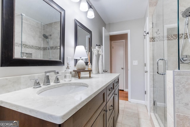 bathroom with tile patterned flooring, vanity, and walk in shower