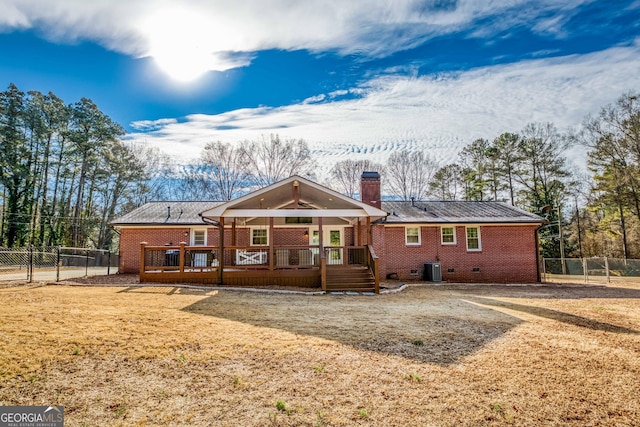 rear view of house with central AC and a wooden deck