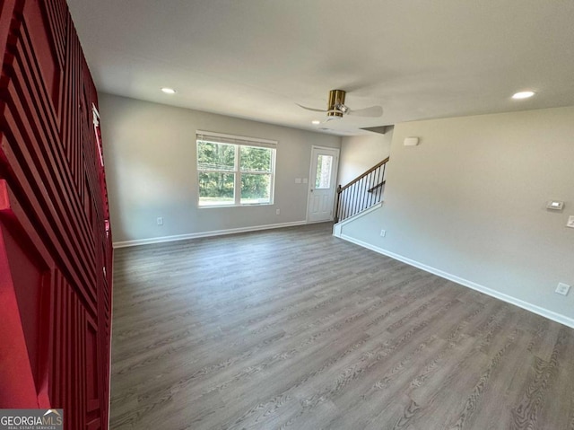 unfurnished room with ceiling fan and wood-type flooring