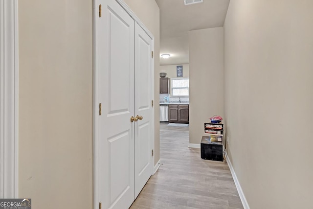 corridor with light hardwood / wood-style floors