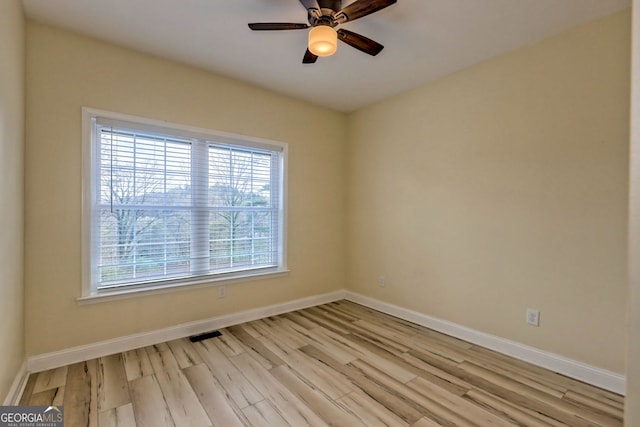 unfurnished room featuring ceiling fan and light wood-type flooring