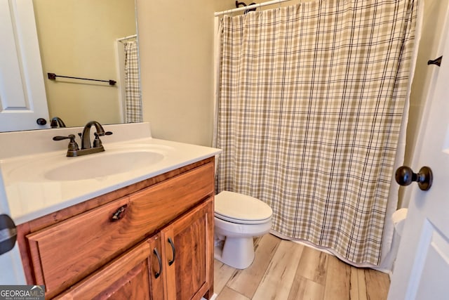 bathroom featuring vanity, toilet, and wood-type flooring