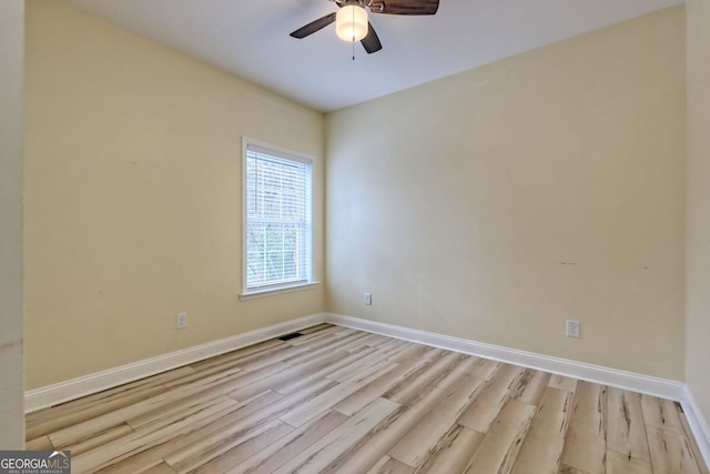 unfurnished room with ceiling fan and light wood-type flooring