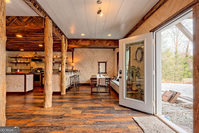 interior space with lofted ceiling, wooden walls, wood ceiling, and dark hardwood / wood-style floors