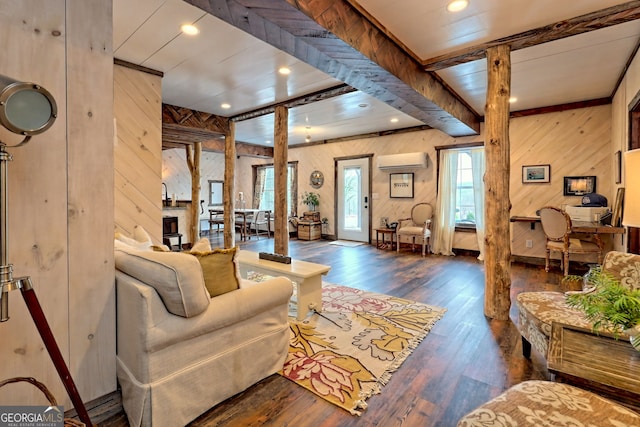 living room featuring wooden walls, a wall unit AC, and dark wood-type flooring