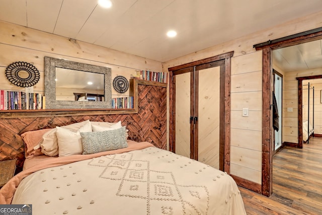 unfurnished bedroom featuring wood walls and wood-type flooring