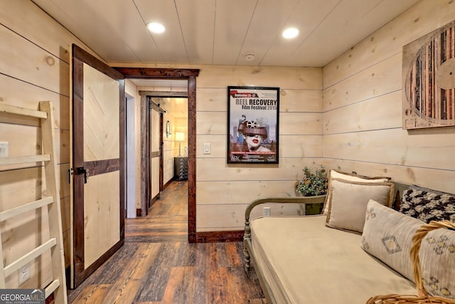 hall featuring dark hardwood / wood-style floors and wood walls