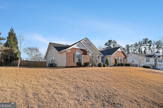 view of front of property with central AC unit and a front yard