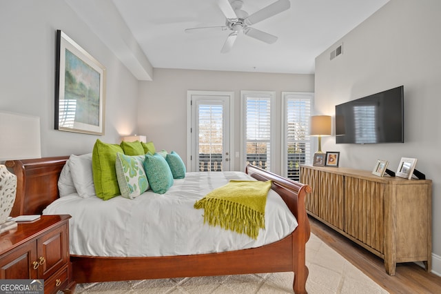 bedroom featuring access to outside, ceiling fan, and light hardwood / wood-style flooring