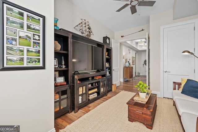 living room with light wood-type flooring and ceiling fan