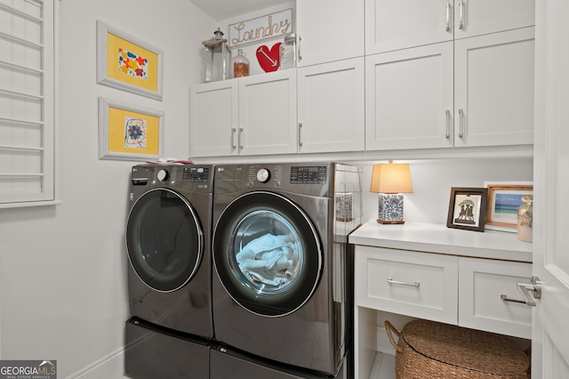 laundry room featuring cabinets and washing machine and dryer