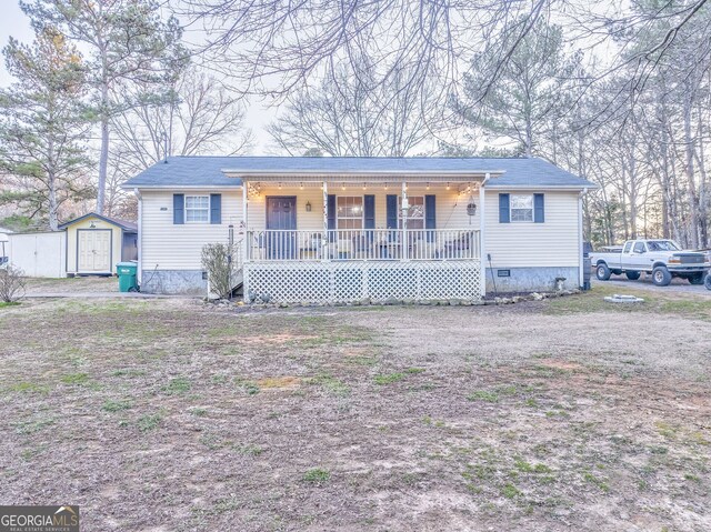 ranch-style home featuring a shed and a porch