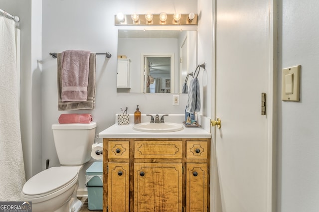 bathroom featuring toilet and vanity