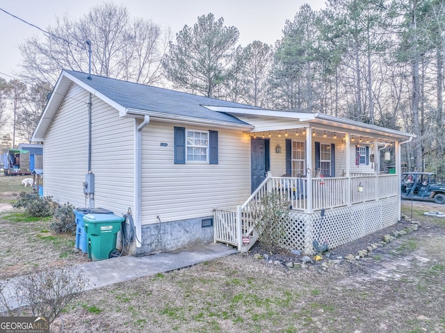 single story home featuring covered porch and crawl space