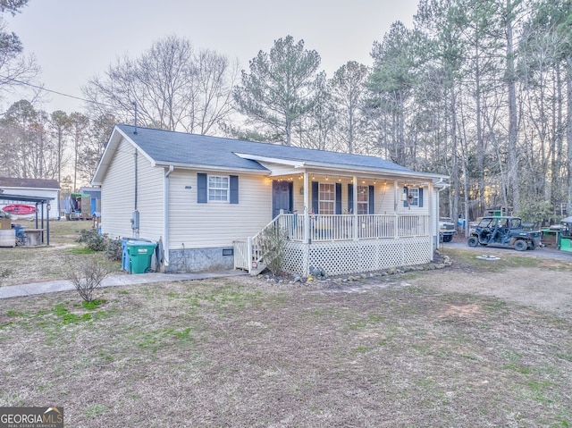 view of front of home featuring a porch and crawl space