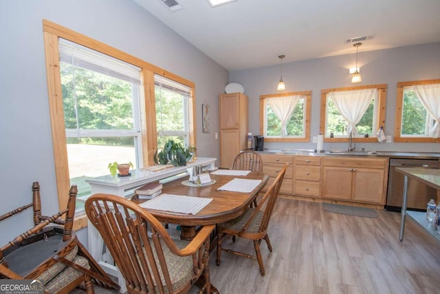 dining space with light hardwood / wood-style floors and sink