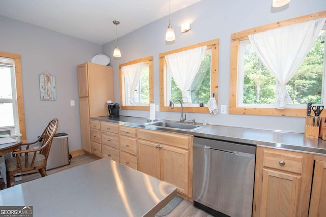 kitchen featuring stainless steel dishwasher, stainless steel counters, sink, light brown cabinets, and decorative light fixtures