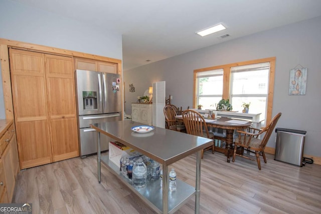 kitchen featuring stainless steel fridge, light hardwood / wood-style floors, and light brown cabinetry