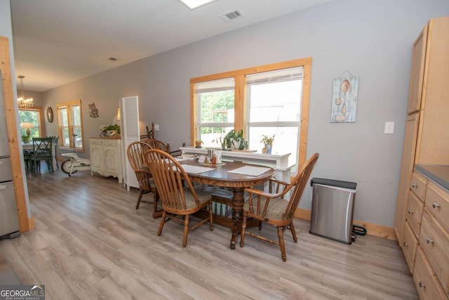 dining room with a notable chandelier and light hardwood / wood-style floors