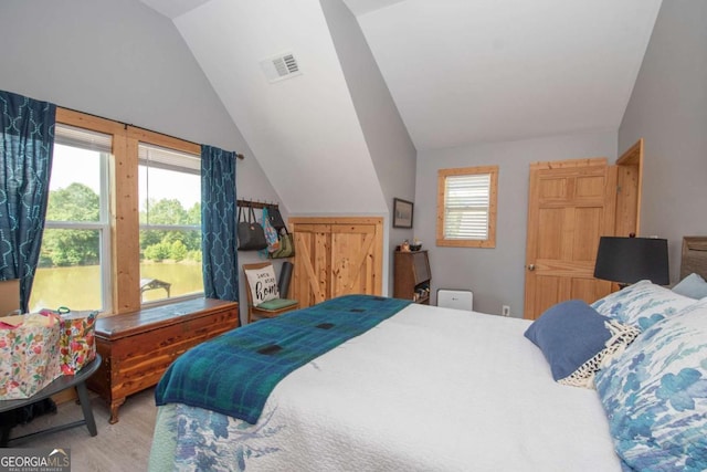 bedroom featuring hardwood / wood-style floors and vaulted ceiling