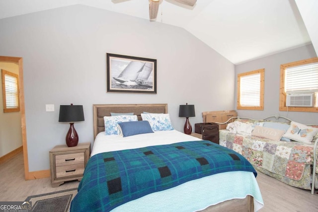 bedroom featuring ceiling fan, cooling unit, light wood-type flooring, and vaulted ceiling