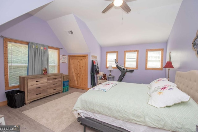 bedroom featuring ceiling fan, lofted ceiling, and light hardwood / wood-style flooring