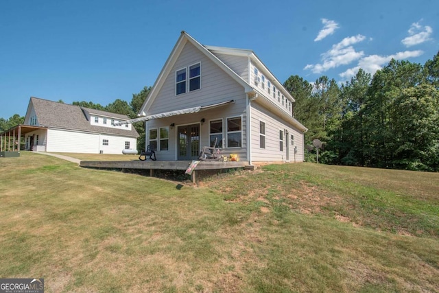 rear view of property with a lawn and french doors