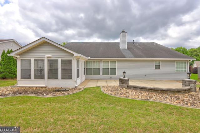 back of house featuring a yard and a patio