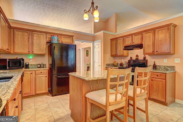 kitchen featuring pendant lighting, black fridge, light tile patterned floors, a textured ceiling, and a notable chandelier