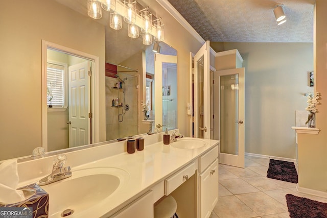 bathroom featuring tile patterned floors, vanity, a textured ceiling, vaulted ceiling, and a shower with door