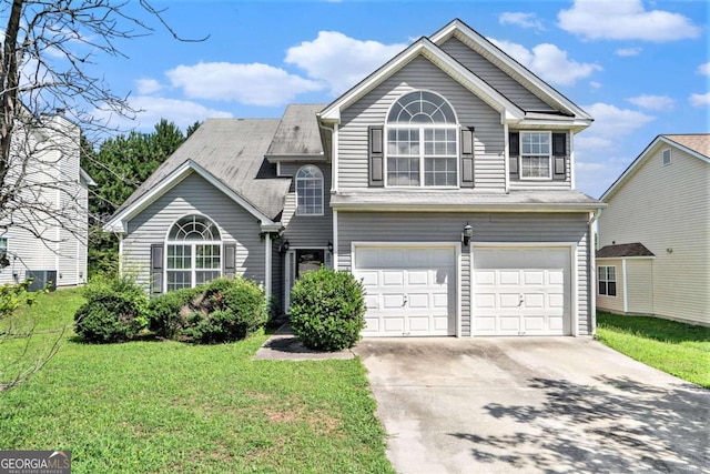 view of front of house featuring a front yard and a garage