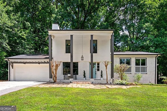 view of front of house with a porch, a front yard, and a garage