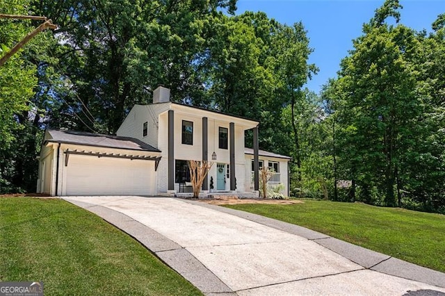 view of front of home with a garage and a front yard