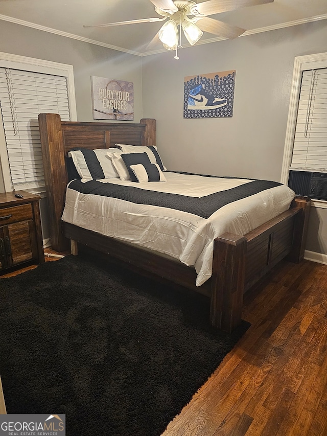 bedroom featuring ceiling fan, dark hardwood / wood-style flooring, and crown molding