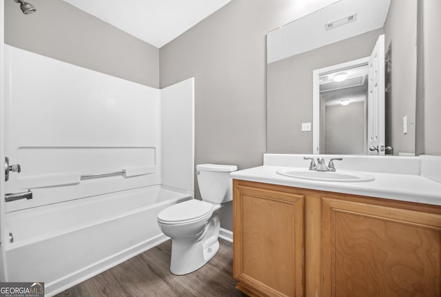 full bathroom featuring wood-type flooring, vanity, toilet, and tub / shower combination