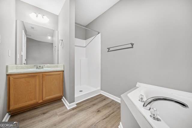 bathroom featuring separate shower and tub, vanity, and hardwood / wood-style flooring