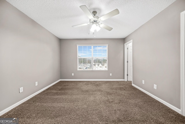 carpeted empty room with ceiling fan and a textured ceiling