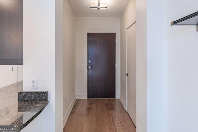 doorway to outside with light wood-type flooring