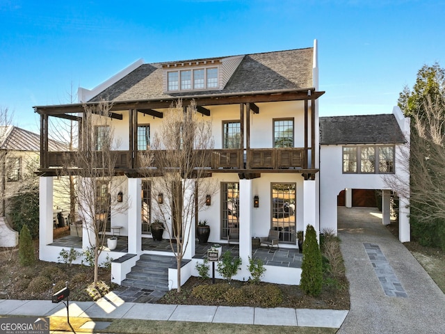 view of front of house with a carport and a balcony