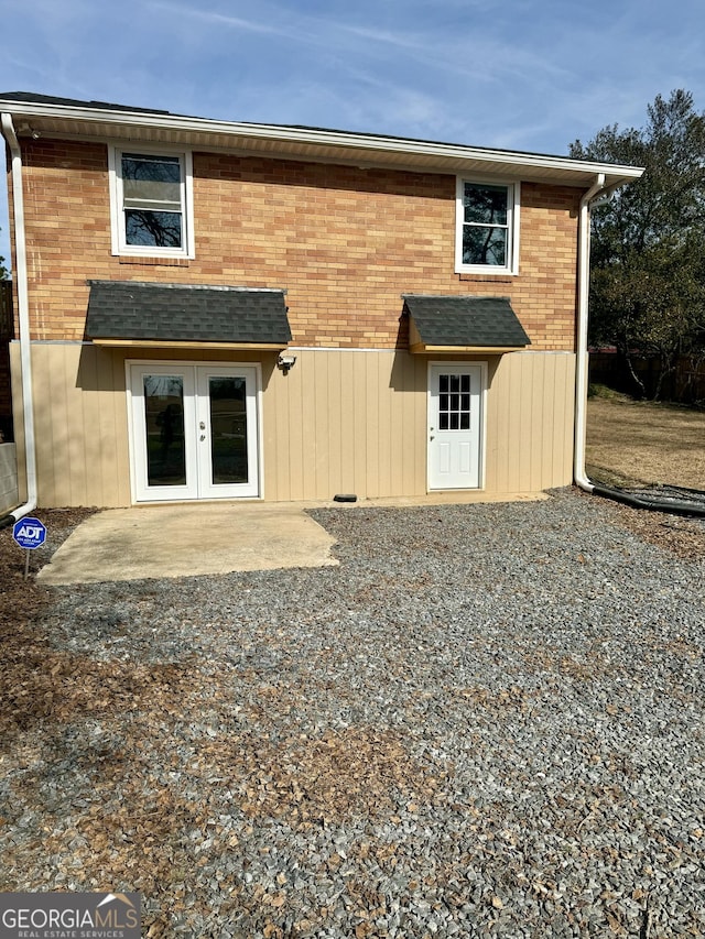 rear view of property featuring french doors and a patio area