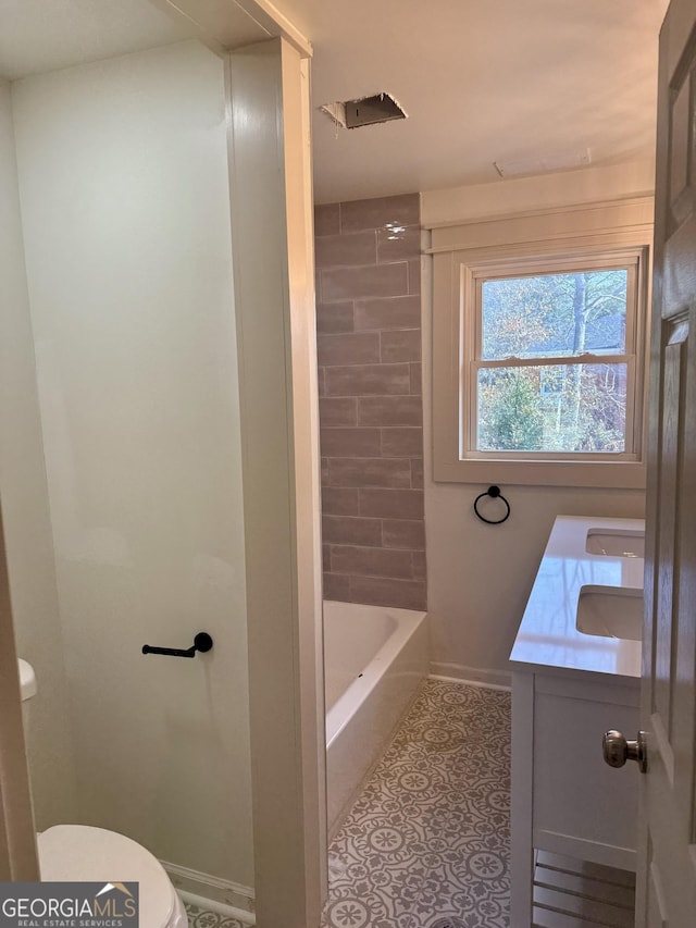 bathroom with vanity, tile patterned floors, and toilet