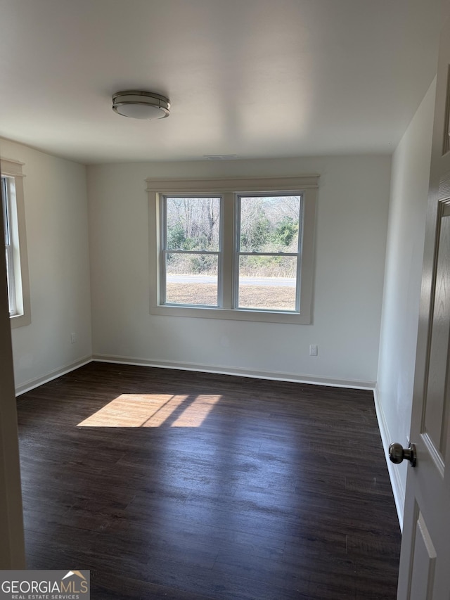 empty room featuring dark wood-type flooring