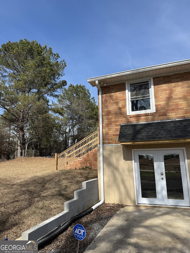 view of side of home with a patio area and french doors