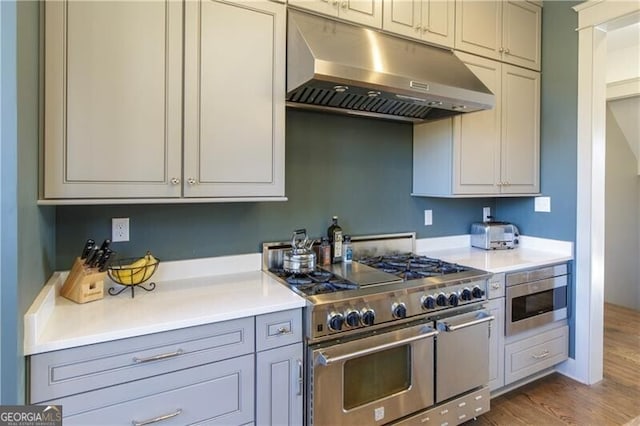 kitchen featuring dark hardwood / wood-style flooring, double oven range, and built in microwave