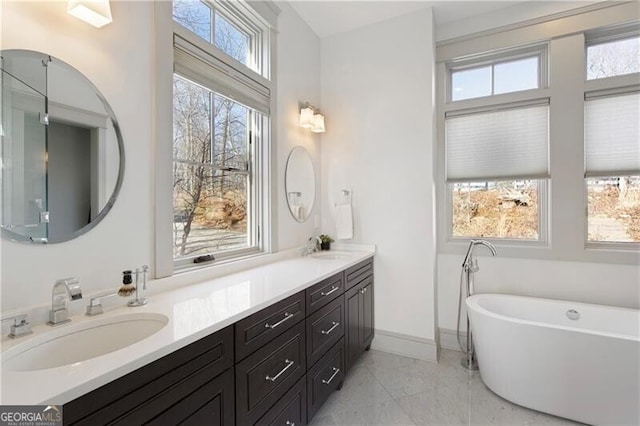 bathroom with vanity and a bath