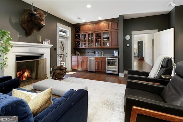 bar featuring dark hardwood / wood-style floors, wine cooler, and sink