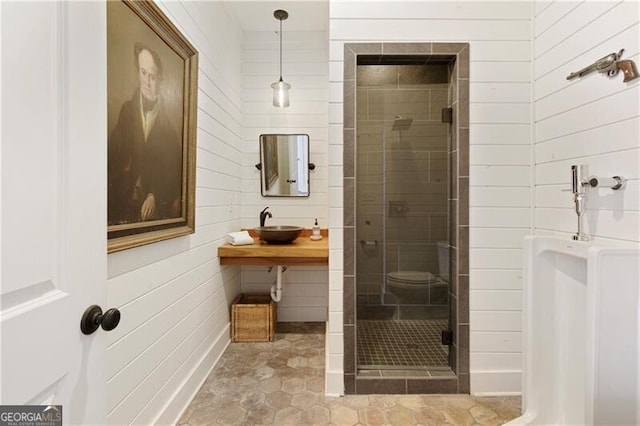 bathroom with tile patterned floors, sink, a shower with door, and toilet
