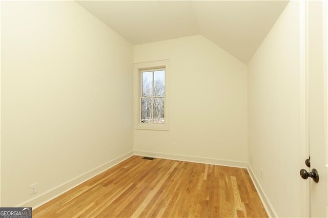 bonus room featuring vaulted ceiling and light wood-type flooring