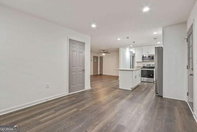 kitchen featuring white cabinetry, a center island, stainless steel appliances, dark hardwood / wood-style flooring, and decorative light fixtures