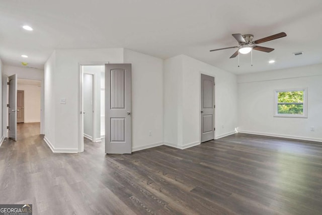 spare room with ceiling fan and dark hardwood / wood-style flooring